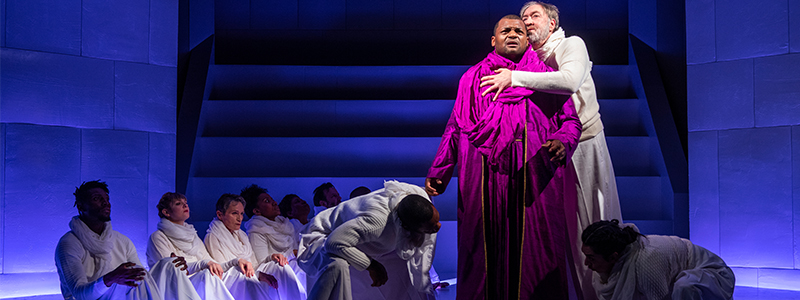 Photo of Kelvin Roston, Jr., Christopher Donahue, and the chorus of OEDIPUS REX (Brosilow).