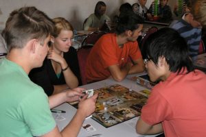 College students playing a game of CLUE.