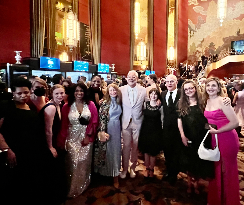 Staff pose in a group in the lobby of Radio City Music Hall prior to the Tony Awards.