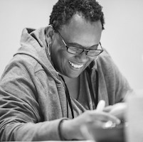 Celeste Williams reading a script and smiling