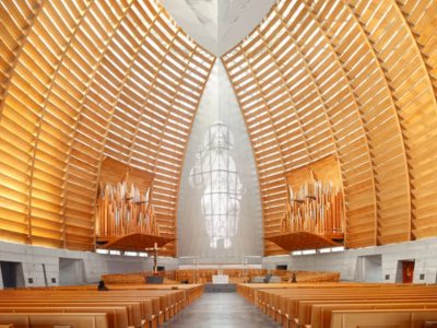 A church space with light wooden beams running up to the ceiling.