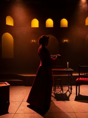 The silhouette of a woman in a red dress.