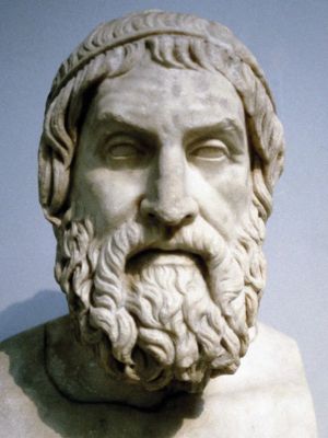 A photo shows a white marble bust of the Ancient Greek playwright Sophocles. He has a curly beard, a focused expression, and wears a circlet in his wavy hair.