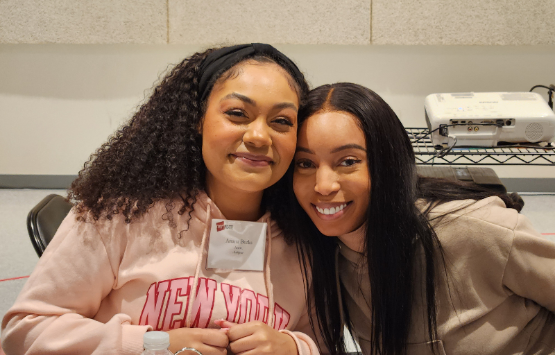 Two women smiling.