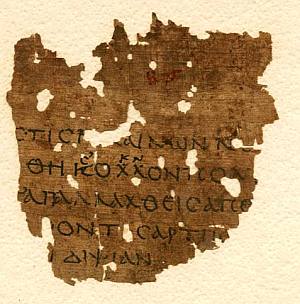 Weathered piece of papyrus with writing on it.