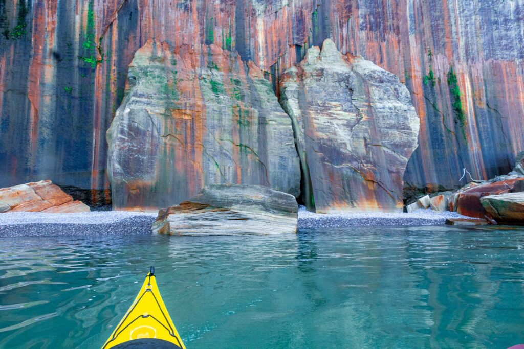 A kayak in front of the Pictured Rocks.