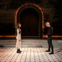 Two people stand facing each other