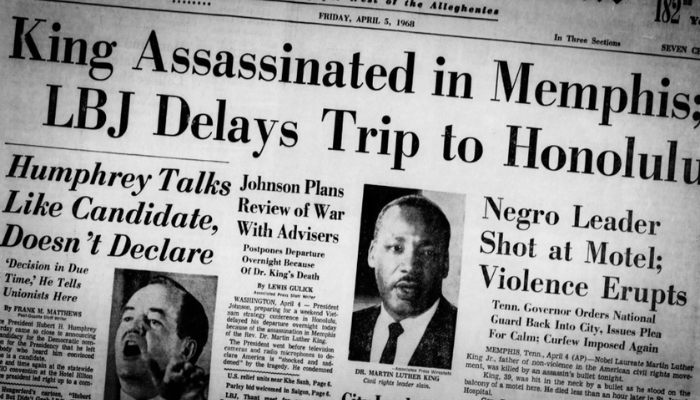 Newspaper with the headline: "King Assassinated in Memphis; LBJ Delays Trip to Honolulu." There is a photo of MLK beneath it, Including several subheadings, reading: "Negro Leader Shot at Motel; Violence Erupts, City Leaders Express Grief in King’s Death."