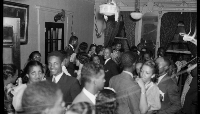 The room is full of young Black couples smiling and dancing.