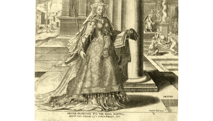 Queen Esther wears a heavily embellished gown and stands in front of a column.