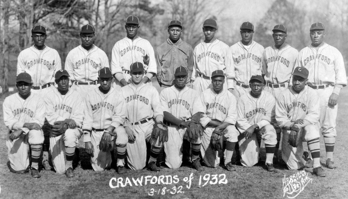 Sixteen players in two rows, wearing uniforms emblazoned with crawfords and baseball hats.